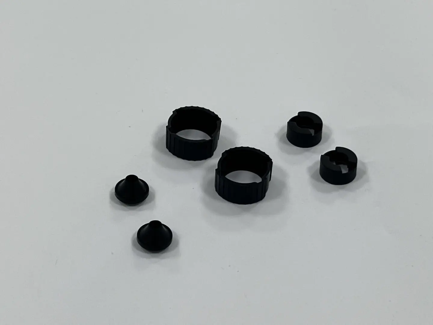 Custom molded black rubber and plastic knurled adjustment rings and seals, mechanical equipment components