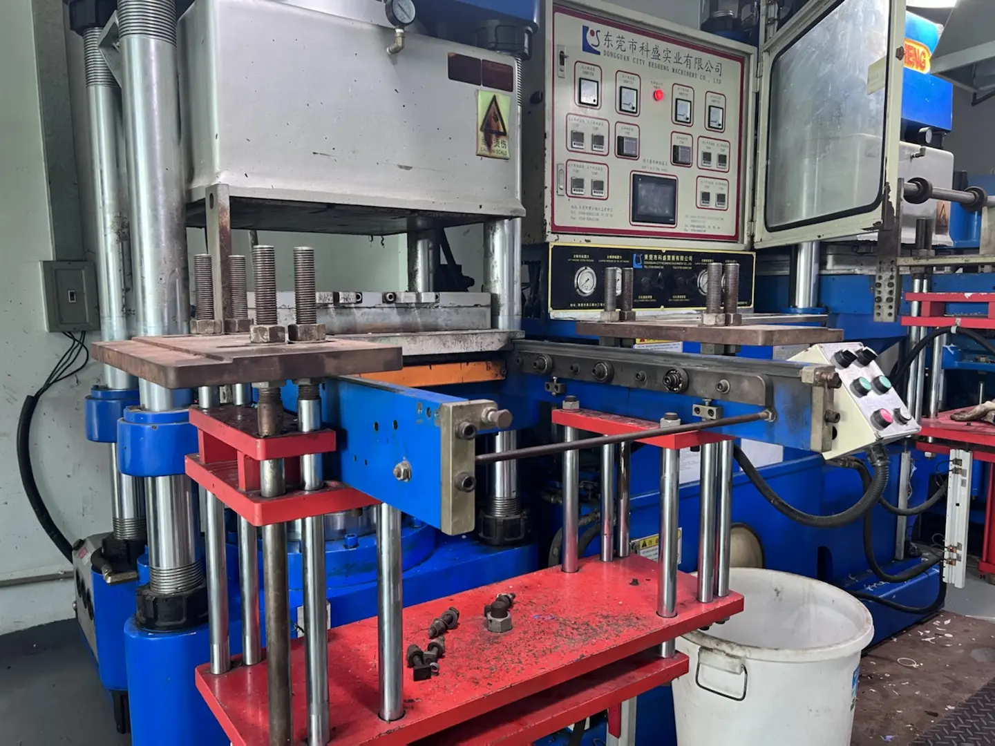 Hydraulic rubber compression molding press machine in factory workshop, silicone and rubber parts manufacturing equipment