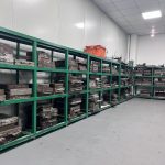 Custom rubber mold storage room with organized tool racks, factory workshop for rubber and silicone compression molds