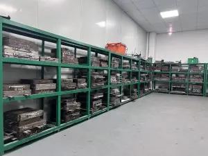 Custom rubber mold storage room with organized tool racks, factory workshop for rubber and silicone compression molds