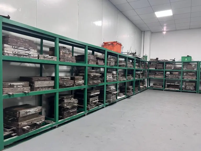 Custom rubber mold storage room with organized tool racks, factory workshop for rubber and silicone compression molds