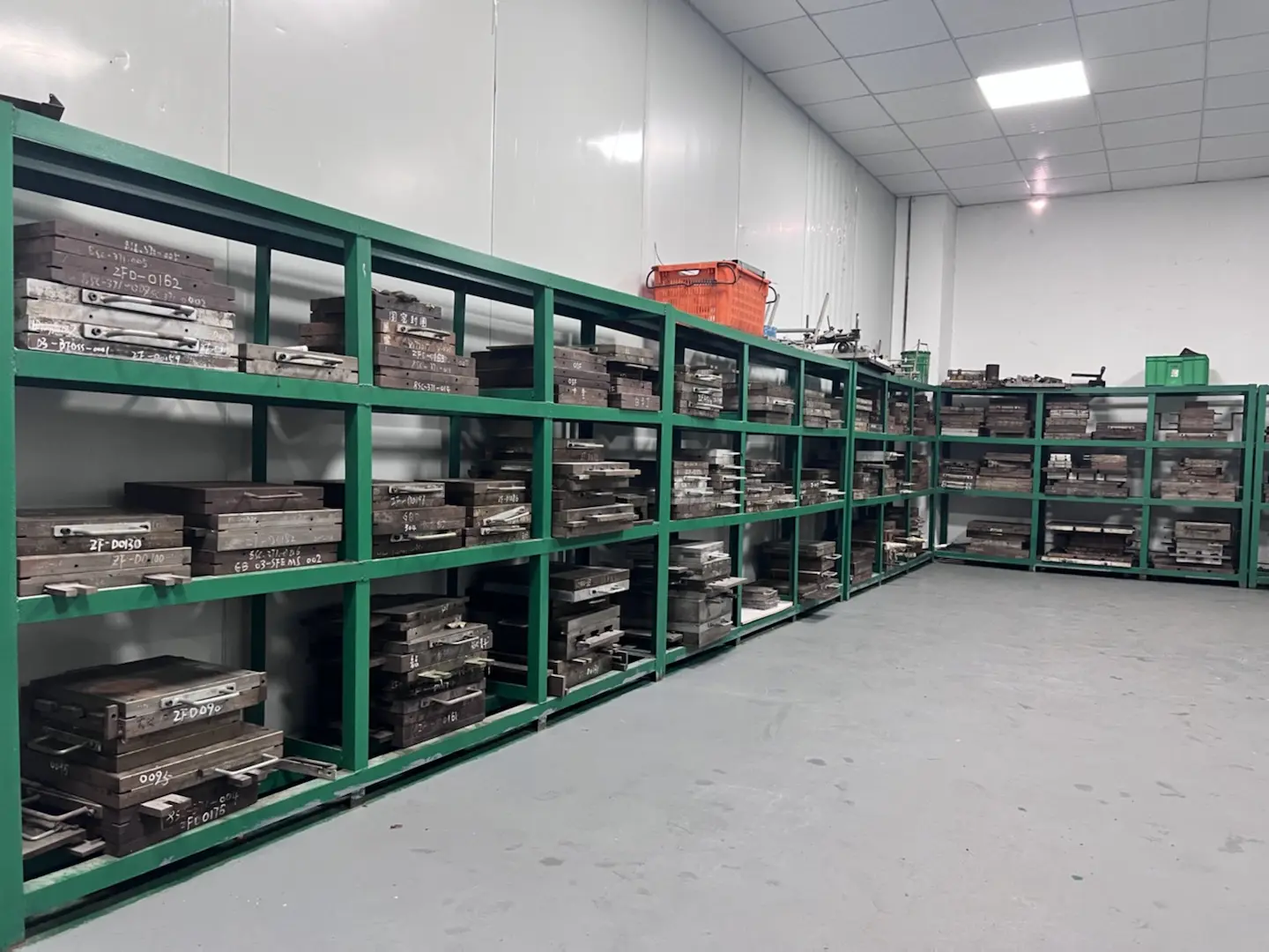 Custom rubber mold storage room with organized tool racks, factory workshop for rubber and silicone compression molds