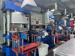 Automatic vacuum rubber compression molding press machine in factory workshop, silicone and rubber parts manufacturing equipment
