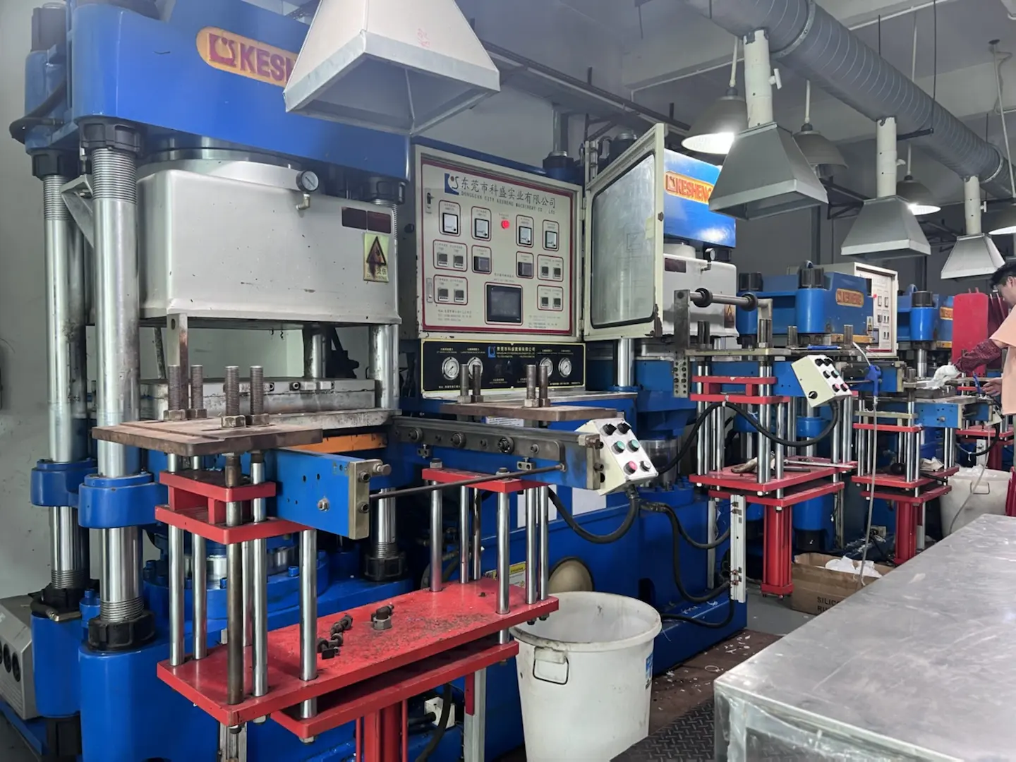 Automatic vacuum rubber compression molding press machine in factory workshop, silicone and rubber parts manufacturing equipment