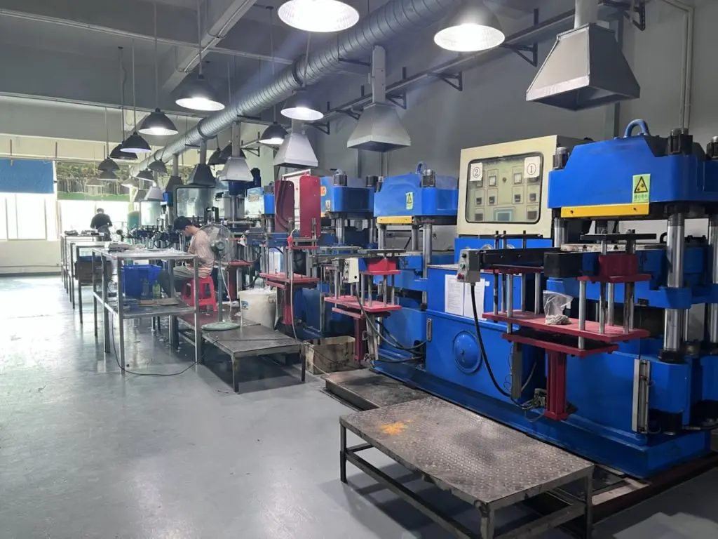Rubber compression molding workshop with multiple automatic hydraulic presses, silicone and rubber parts manufacturing factory floor
