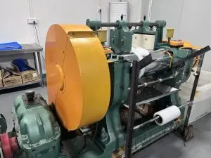 Silicone rubber mixing mill in factory workshop, two-roll rubber mixing machine for raw material preparation