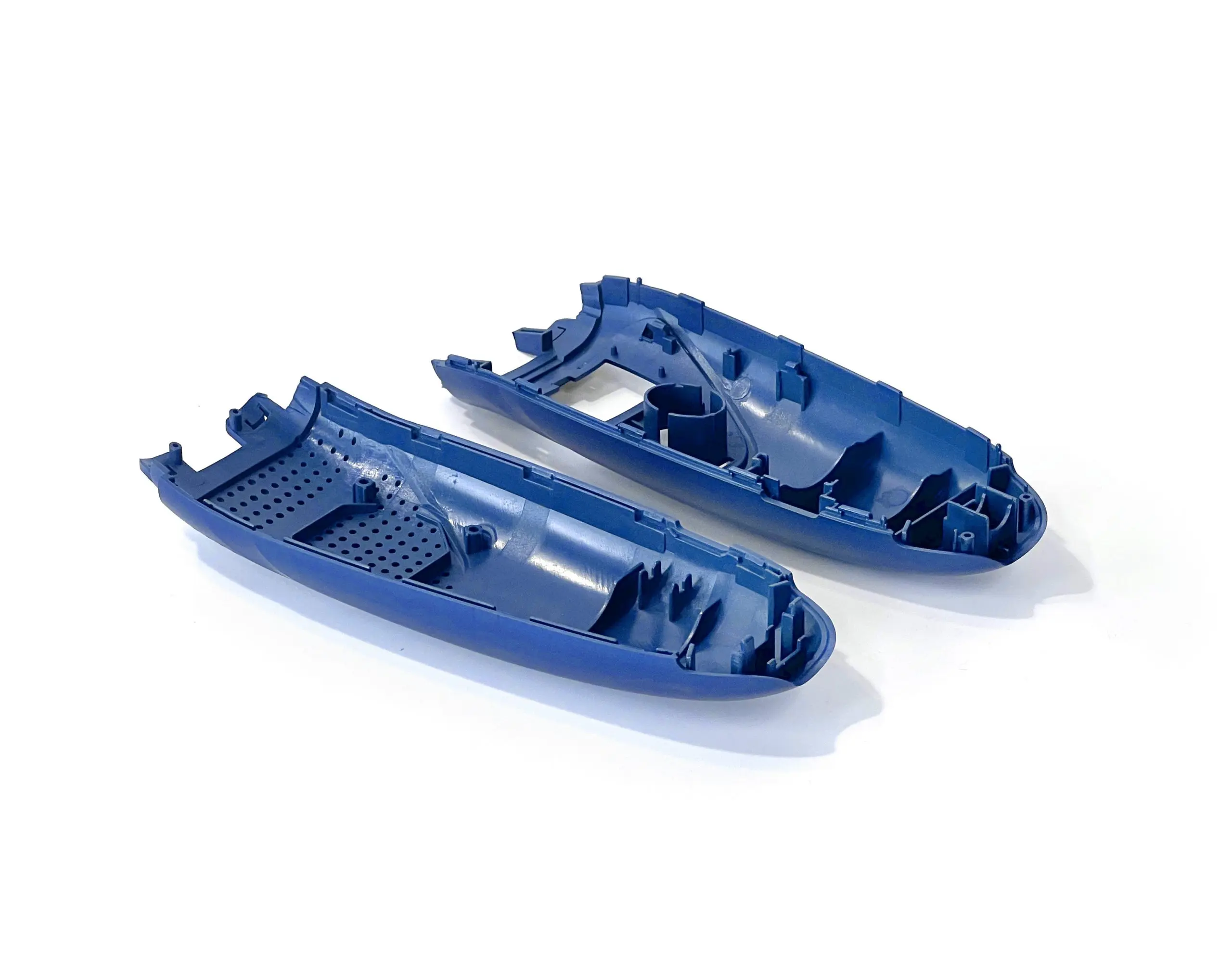 Custom injection molded plastic parts for electronic enclosures, featuring precise detailing and perforations, ideal for product housings and industrial applications.