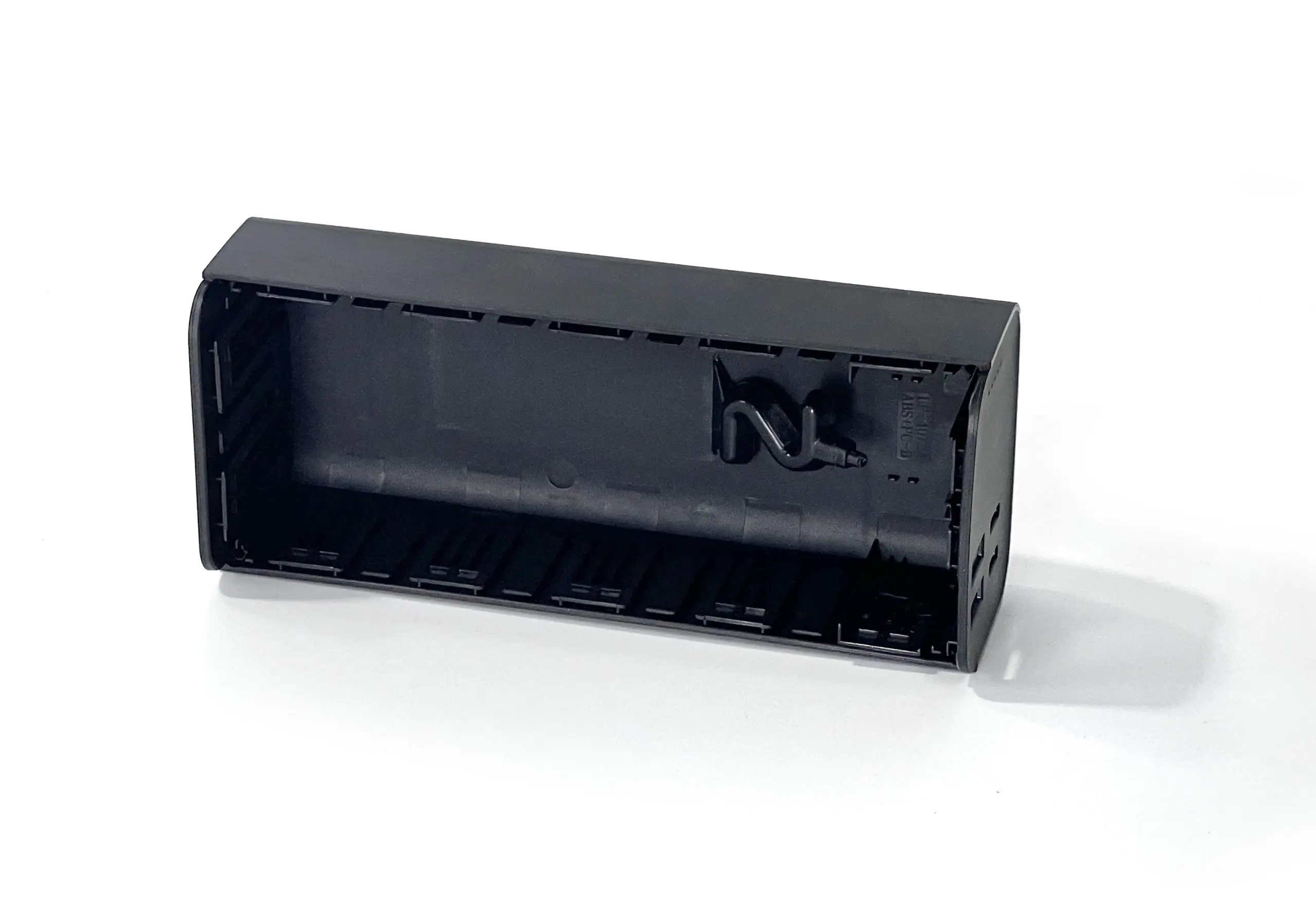 High-quality black plastic injection molded enclosure with internal features for secure component placement, designed for electronic applications requiring durability and precision.