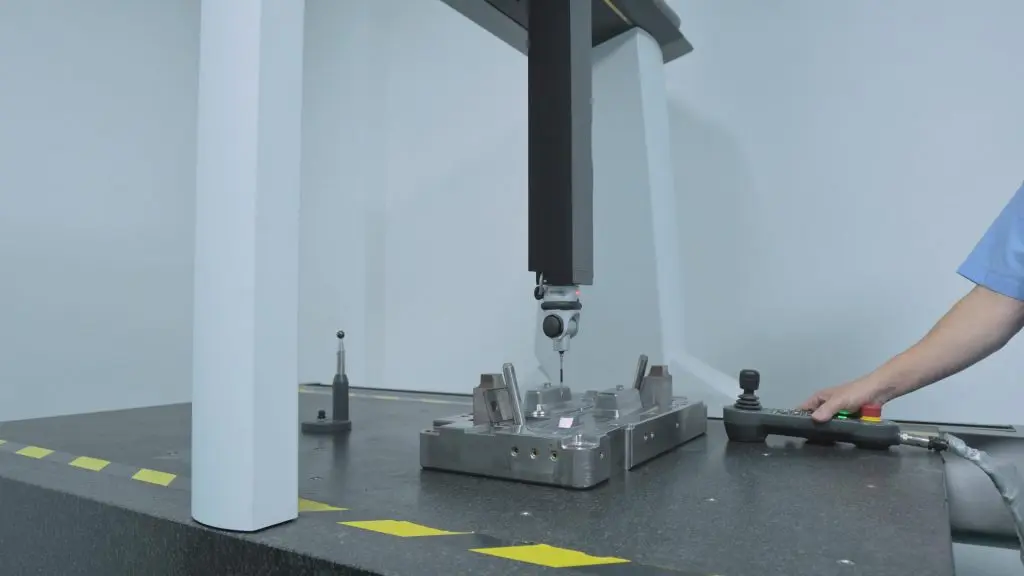 CMM inspection for injection mold components, operator performing precision quality control in mold making