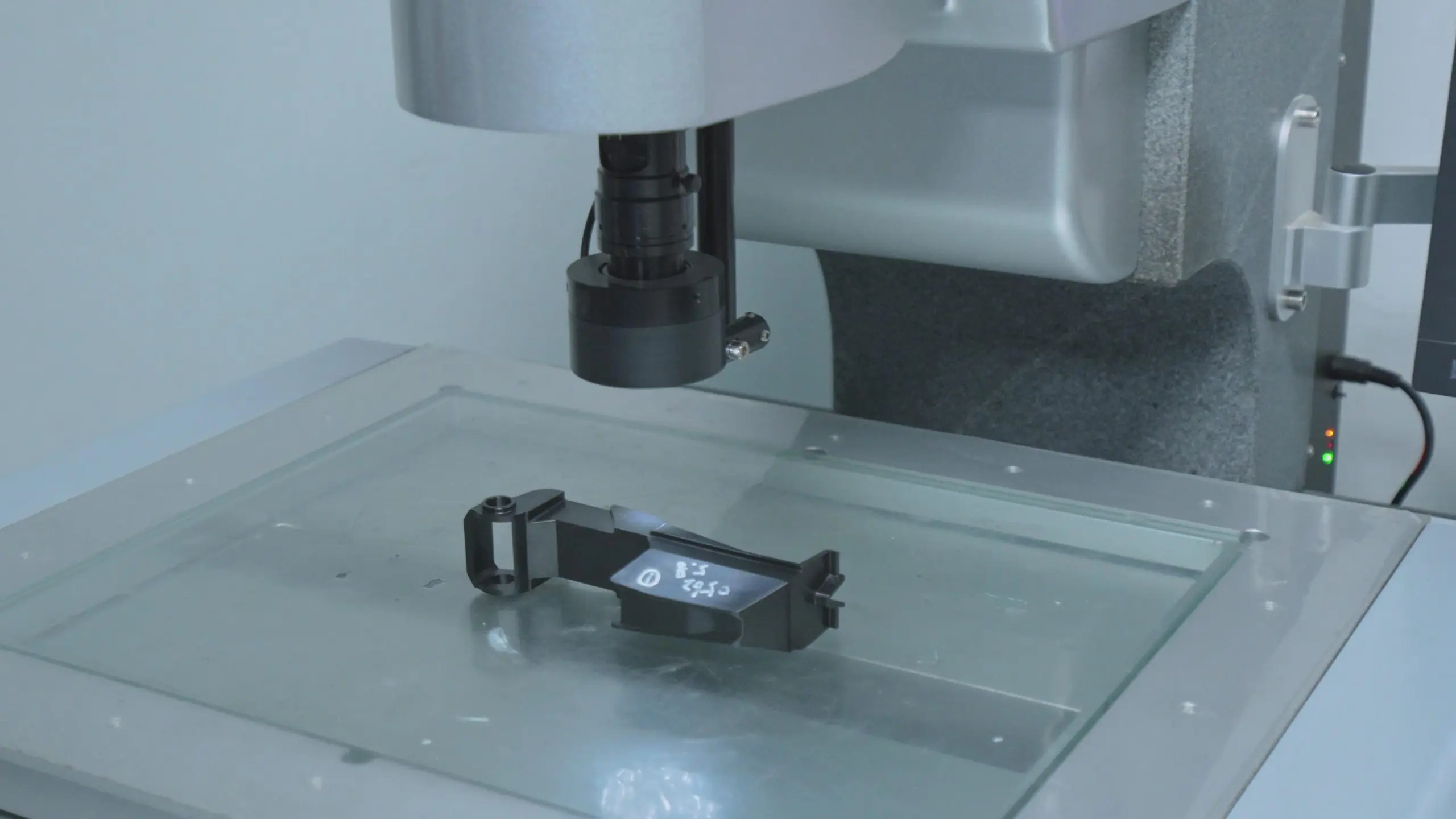 Vision Measuring Machine (VMM) inspecting a precision plastic injection molded part, 2D dimensional quality control check