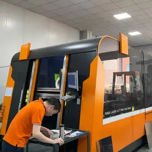Industrial Fiber Laser Cutting Machine in Operation, Metal Fabrication Factory Worker Preparing CNC Laser Cutting Process